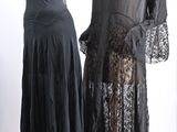 two mannequins dressed in black clothing and lace on display