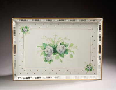 a tray with flowers painted on it on a table
