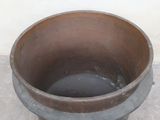 a brown pot sitting on the floor next to a white wall