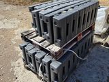 a pile of black plastic containers sitting on the ground