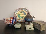 une table sur laquelle se trouvent un bol, une assiette et une théière