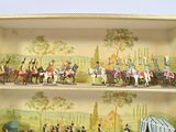 many figurines of people riding horses on a shelf