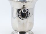a silver cup that has a handle on it