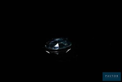 a close up of a diamond on a black surface