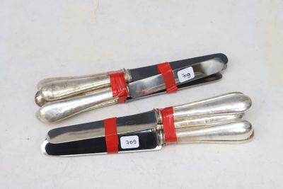 two knives that are sitting next to each other on a table