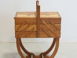 an image of a wooden box with a handle on a stand