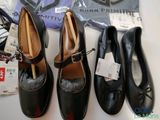 several pairs of black shoes are lined up on a table