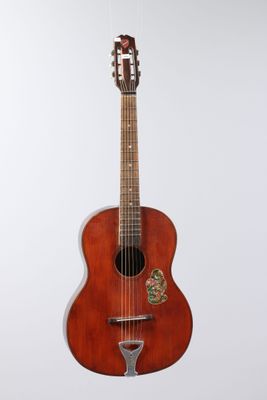 an image of a guitar hanging on a wall on a white background