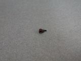 a small red object on the floor of a room