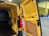 a yellow van with its door open in a warehouse