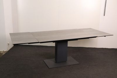 an image of a table in a room with a black base