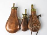 three antique brass lamps hanging on a wall