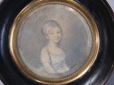 portrait of a woman in a white dress in a black and gold frame