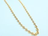a gold chain necklace with a medallion design on a blue background