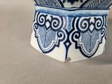 a blue and white vase sitting on a table