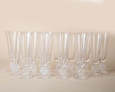 six empty wine glasses lined up on a table