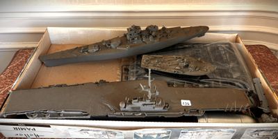 a cardboard box with a model of a battleship in it