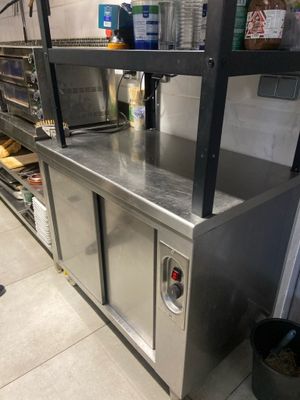 a kitchen with stainless steel counter tops and shelves