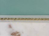 gold rope on a white marble counter top