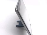 a tablet computer sitting on a stand on a white surface