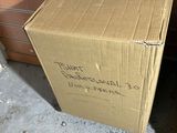 a cardboard box sitting on top of a desk next to a computer