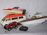 a toy boat and a toy truck next to a boat