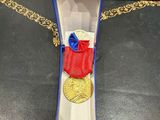 an image of a medal in a box on a table