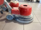 a red machine that is sitting on the floor