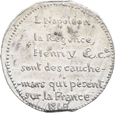 a close up of a silver coin with writing on it