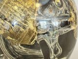 a black and gold vase with a gold leaf on it