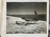 black and white photograph of an airplane on a snowy surface