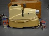 a yellow piece of luggage sitting on the floor next to a box