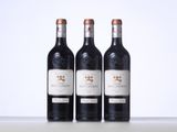 three bottles of wine sitting on top of a table next to each other