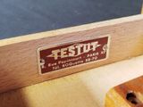 a close up of a wooden bench with a sign on it