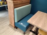 a booth with a table and a bench in the corner