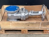 a metal ball valve sitting in a wooden crate
