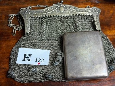 a silver purse with a chain around it on a table