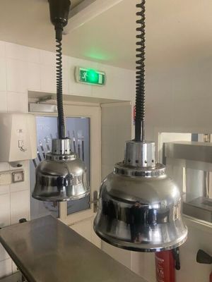 two lights hanging from the ceiling in a kitchen