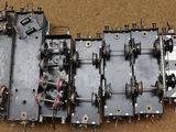 an overhead view of a group of metal parts sitting on top of a brown surface