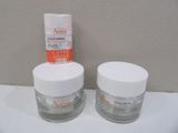 two jars of creams sitting on a counter