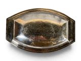 a silver plate with a mirror in it on a white surface