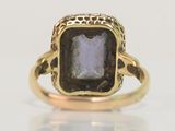 a close up of a ring with a stone in it