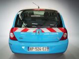 a small blue car with a red and white stripe on the back