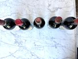 several bottles of wine are lined up on a marble table