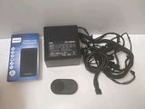 an image of a remote control and a charger on a table