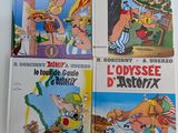 quatre albums de bandes dessinées posés sur une table, sur fond blanc