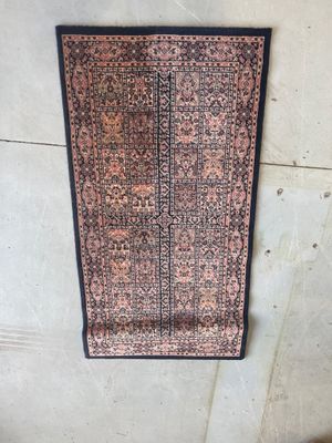 a rug on the floor with a black border on it