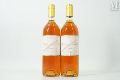 two bottles of wine sitting next to each other on a table