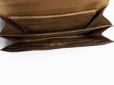 the inside of a brown leather purse with a long strap