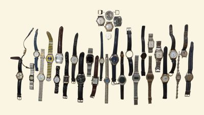 many different types of watches displayed on the wall